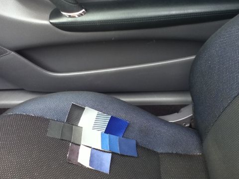 2006 Ford E350 - Fabric swatches are placed on the seat of a vehicle for color matching.