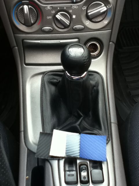 2006 Ford E350 - Samples of materials are laid out on the center console near the gear shifter in this car interior.