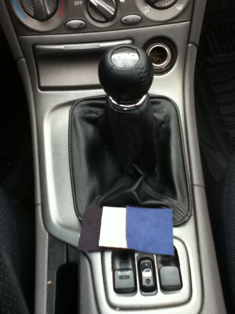 2006 Ford E350 - Close-up of a car's interior center console, showing the gear shift and window controls.