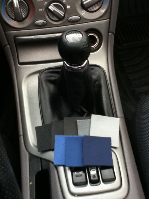 2006 Ford E350 - Interior view of a car's center console with a shift boot and various material swatches.