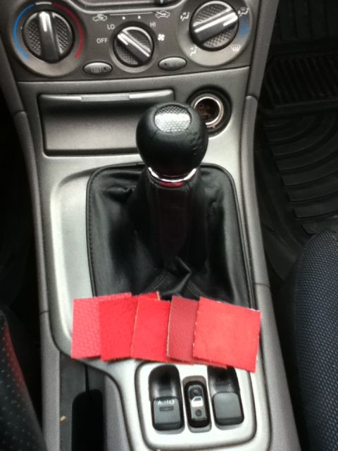 2006 Ford E350 - Swatches of red material are placed on the center console near the gear shifter and window controls.