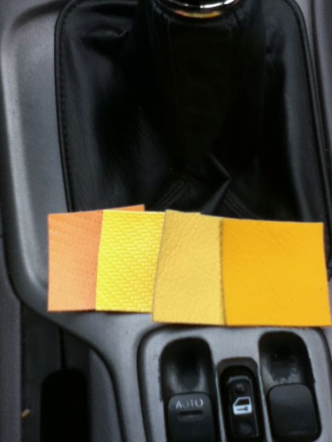 2006 Ford E350 - Fabric swatches are displayed on a vehicle's center console, near the gear shifter and power window controls.