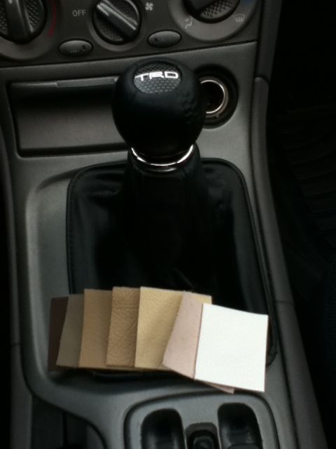 2006 Ford E350 - Leather swatches are displayed on the center console next to a TRD shift knob.