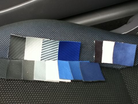 2006 Ford E350 - Swatches of interior trim materials are displayed on a textured surface, likely for color matching.