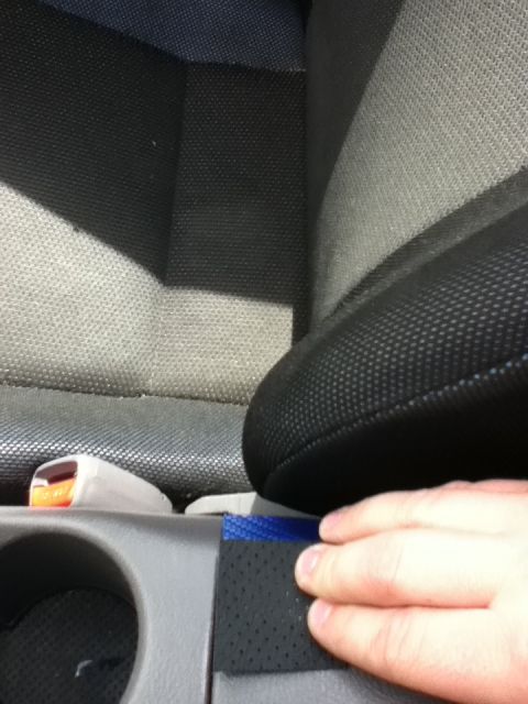 2006 Ford E350 - Interior view of a vehicle, focusing on the seatbelt buckle and seat fabric.
