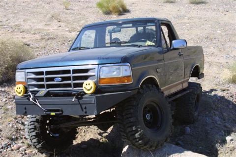 1994 Ford Bronco - This lifted Ford Bronco is equipped with off-road tires and a custom bumper, ready for adventure.