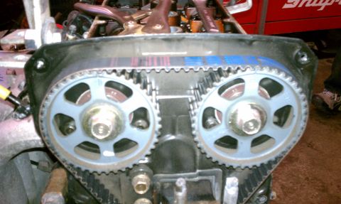 1999 Ford Expedition - Engine timing belt and gears are visible, with tools in the background.