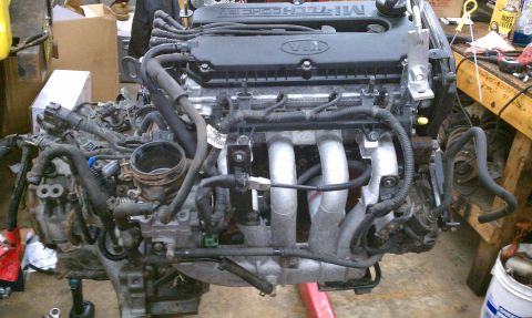 1999 Ford Expedition - Engine assembly with "KIA" logo and "MI-TECH DOHC" text visible on the valve cover.