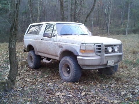1996 Ford Bronco - This 1996 Ford Bronco is parked off-road in a forest during autumn.