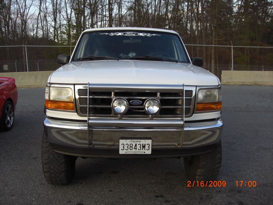 White 1996 Ford Bronco front view with chrome bull bar and fog lights