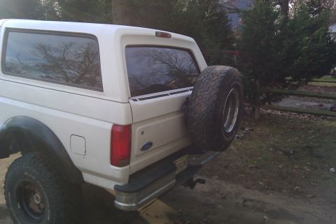 1996 Ford Bronco - This 1996 Ford Bronco is seen from the rear, a spare tire mounted externally on the tailgate.