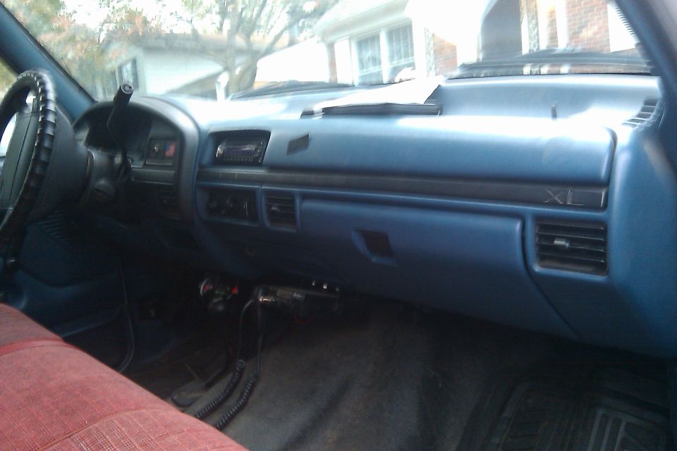 dashboard and passenger seat of a truck, shows radio, vents, and 'XL' trim