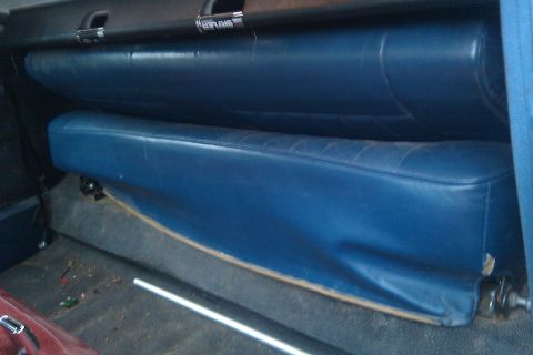 1996 Ford Bronco - Interior view of blue vinyl rear seats and dashboard trim.