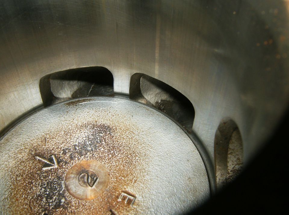 Close-up of engine cylinder with visible markings and wear