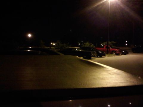 1996 Ford Bronco - Nighttime view of a parking lot with multiple vehicles, including a red truck.