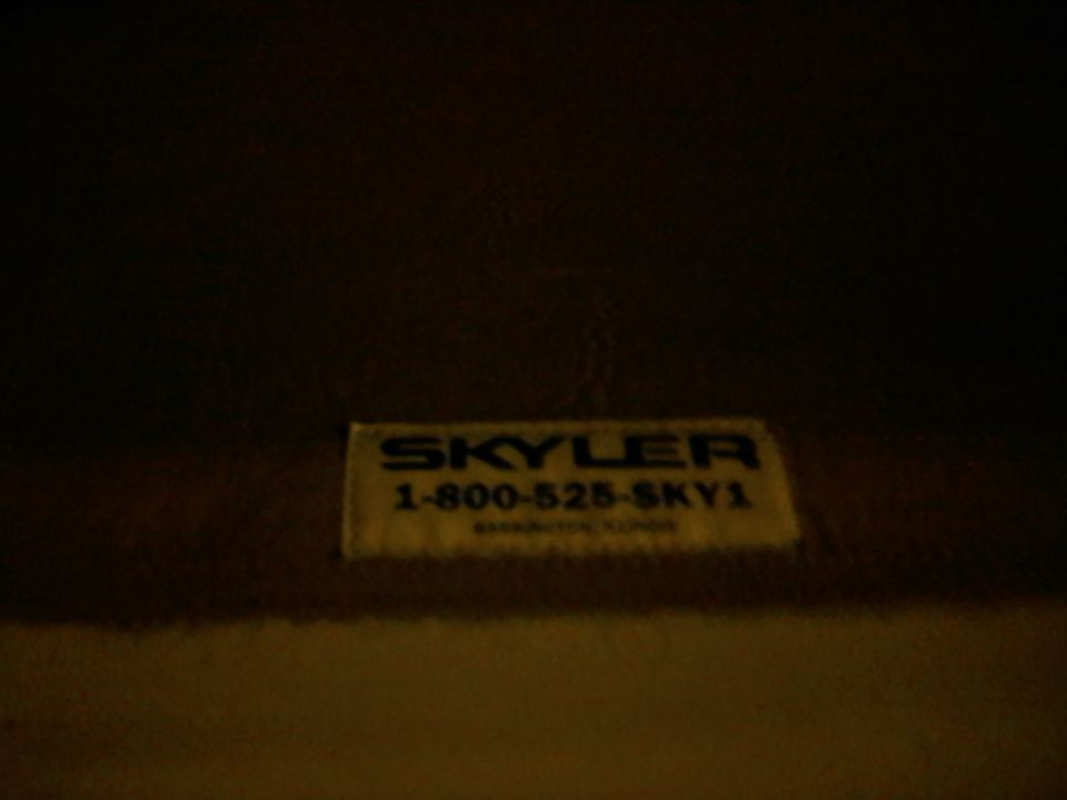 Yellow sticker with blue text reading "SKYLER 1-800-525-SKY1" and smaller text below