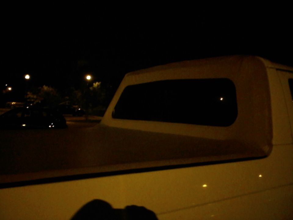 White soft top on a vehicle at night
