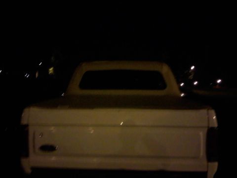 1996 Ford Bronco - Rear view of a white 1996 Ford Bronco its distinctive soft top.