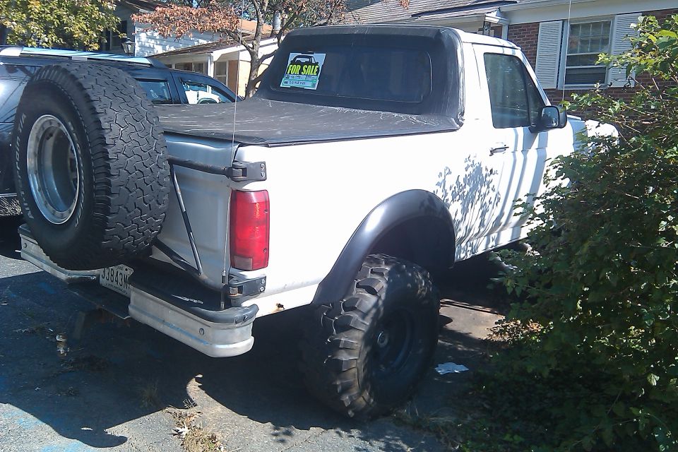 1996 Ford Bronco with soft top and spare tire mounted on rear bumper