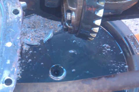 1996 Ford Bronco - Close-up view of a differential gear showing signs of water contamination and rust.