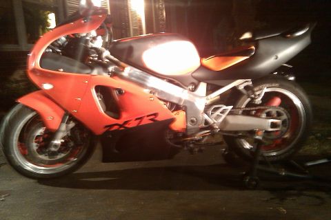 1996 Kawasaki Ninja R - Side view of a 1996 Kawasaki Ninja ZX-7R motorcycle with orange and black bodywork.