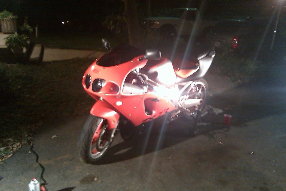 Red sport motorcycle parked at night