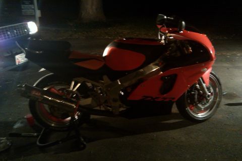 1996 Kawasaki Ninja R - A red and black 1996 Kawasaki Ninja R motorcycle is parked outdoors at night.