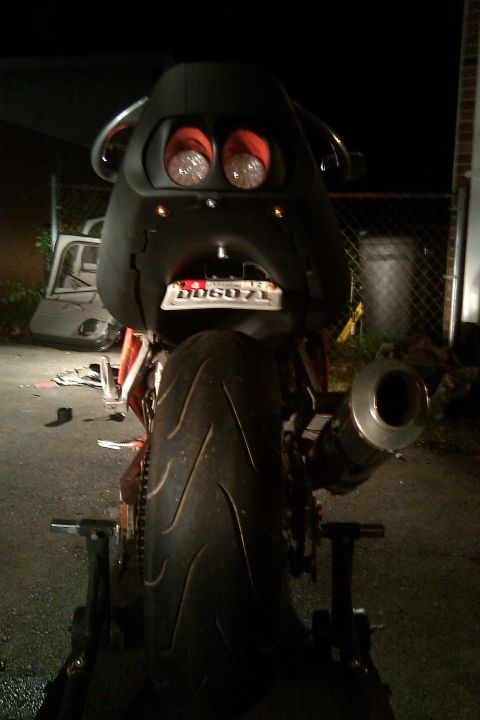 1996 Kawasaki Ninja R - Rear view of a modified motorcycle with a unique headlight design and custom exhaust pipe.