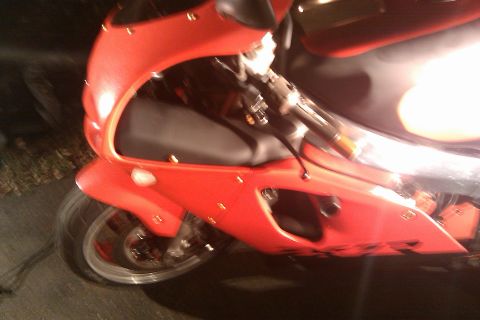 1996 Kawasaki Ninja R - A red sport motorcycle is shown from a high angle, focusing on its front fairing and seat.
