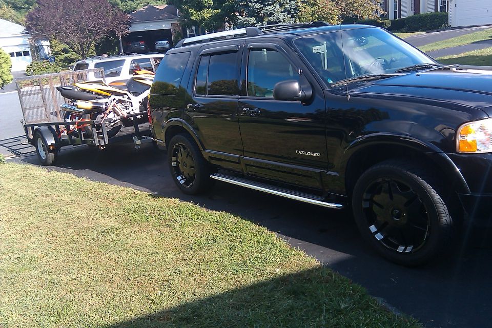 Black 2005 Ford Explorer towing a trailer with jet skis