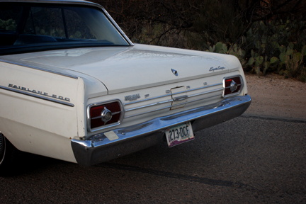 1965 Ford Fairlane - Rear view of a white 1965 Ford Fairlane 500 showing its distinctive taillights and chrome bumper.