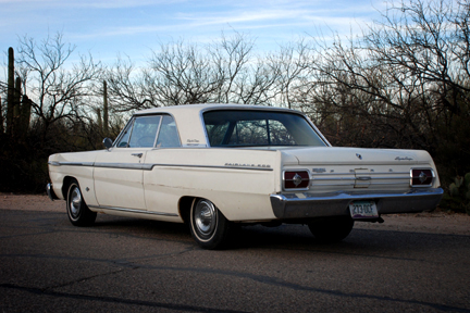 1965 Ford Fairlane - Rear view of a 1965 Ford Fairlane 500 in a desert landscape.