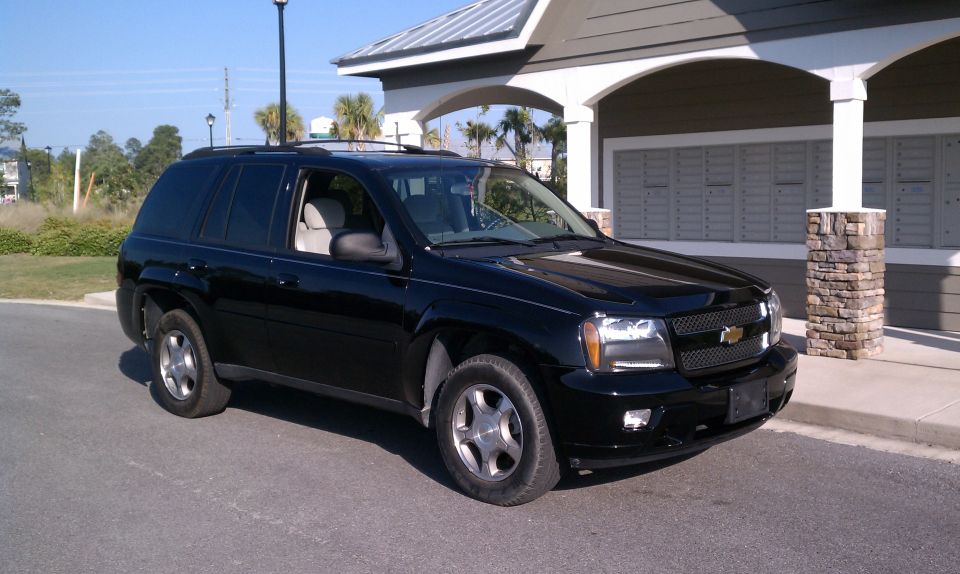 Black Chevrolet TrailBlazer SUV parked, front three-quarter view near mailboxes
