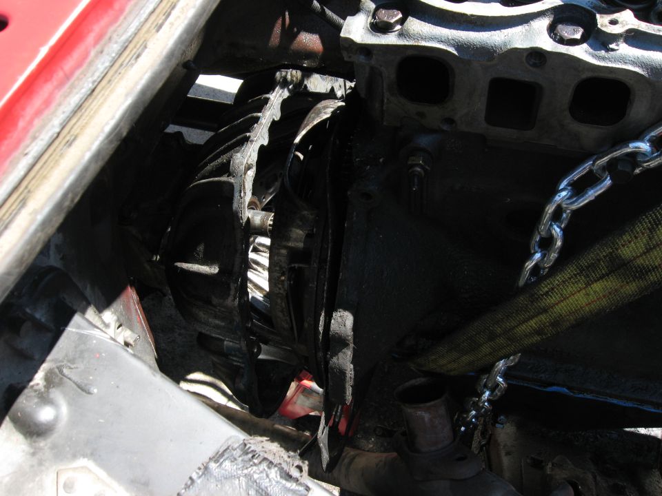 engine block and transmission bell housing with chains and straps attached