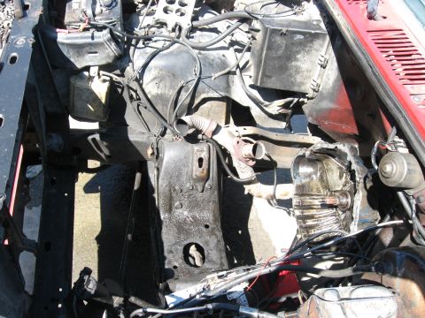 1981 Ford Bronco - The engine bay shows a disassembled engine and transmission, with exposed wiring and a red fender.