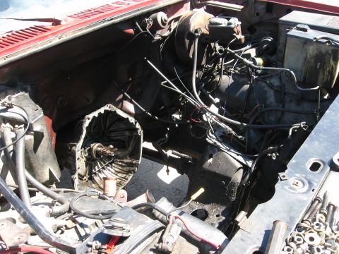 1981 Ford Bronco - Vehicle engine bay with transmission removed, showing internal components and wiring.
