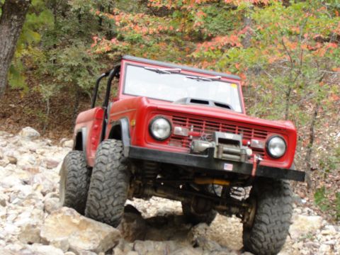 1967 Ford Mustang - This modified Ford Bronco navigates a challenging rocky path, its off-road capabilities.
