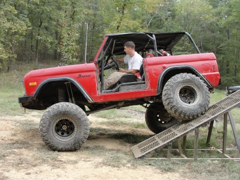 1967 Ford Mustang - This red Ford Bronco is equipped for off-roading and is shown climbing a ramp.