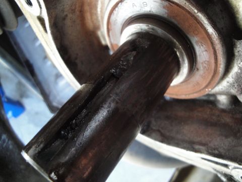 1995 Ford Taurus - A close-up view of a worn automotive part, showing grease and metal markings.