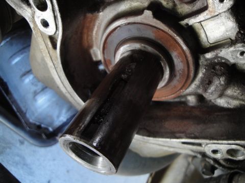 1995 Ford Taurus - Close-up view of an engine crankshaft seal area, showing a part inserted into the housing.