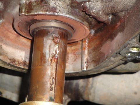 1995 Ford Taurus - This close-up shows a heavily rusted metal shaft and its surrounding housing, indicating significant wear and potential mechanical issues.