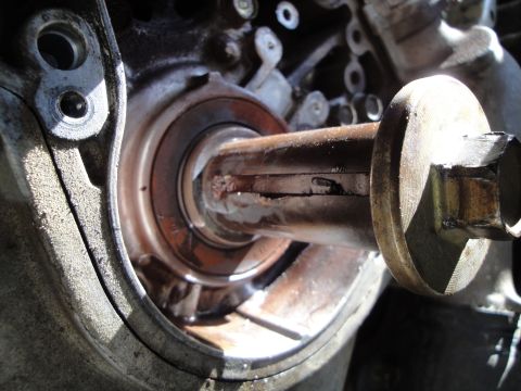 1995 Ford Taurus - A close-up view reveals a damaged engine shaft and bearing, suggesting mechanical wear or failure.