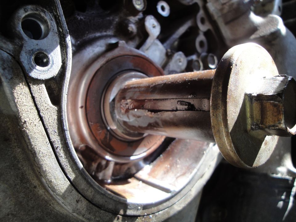 Close-up of a damaged engine shaft and bearing