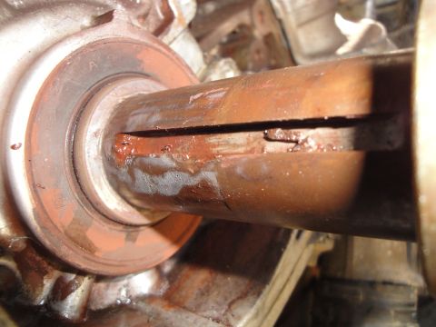 1995 Ford Taurus - Close-up view of a corroded metal shaft, showing signs of wear and fluid leakage.