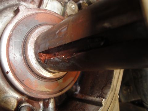 1995 Ford Taurus - A close-up view shows a damaged shaft seal with visible rust and red grease.