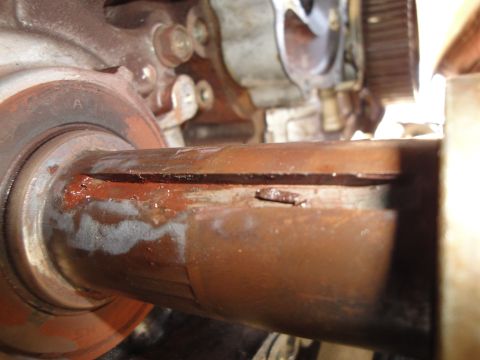 1995 Ford Taurus - A damaged metal shaft shows significant rust and a deep crack, indicating mechanical failure.