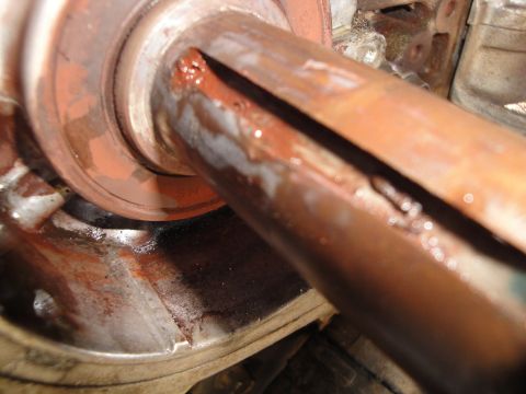1995 Ford Taurus - Close-up view of a corroded metal shaft with a visible slit, indicating potential mechanical wear or damage.