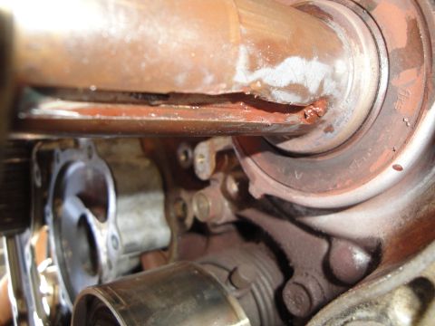 1995 Ford Taurus - Detail of a damaged engine part, showing signs of rust and wear.