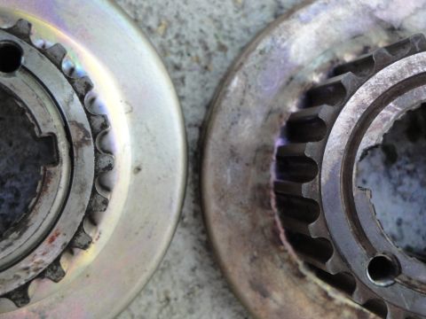 1995 Ford Taurus - Close-up view of two metal sprockets, showing their toothed edges and central splines.