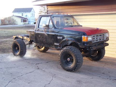 1988 Ford F-250 - This lifted pickup truck, likely from the late 1980s, features oversized tires and a modified chassis, suggesting it's built for off-road u…